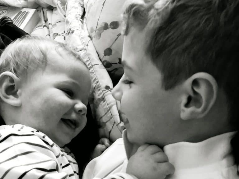 Brothers cuddles siblings