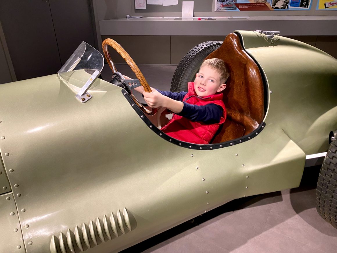 sitting in a replica racing car