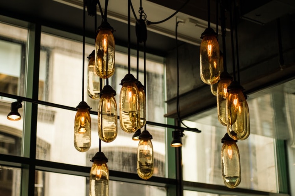 Industrial interior lights hanging from a metal roof